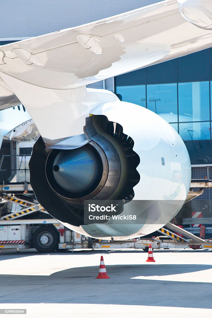 Jet Engine Nozzle with Chevrons Jet engine nozzle at a large airplane, new type of engine with chevrons. Chevrons are the sawtooth patterns on the trailing edges of some jet engine nozzles that are used for noise reduction. Airplane Hangar Stock Photo