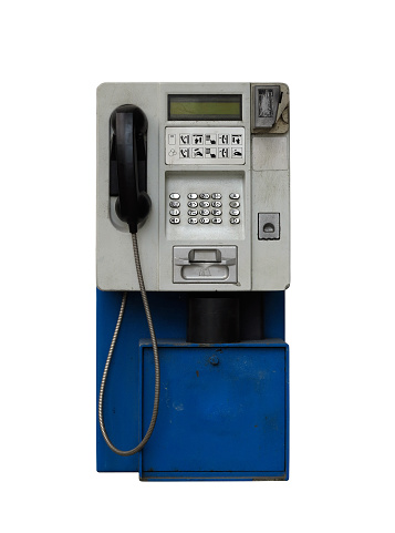 Detail of the old payphone on white background
