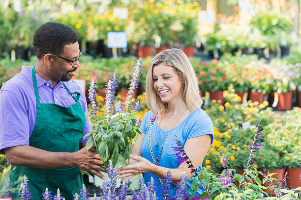 istock Worker in plant nursery helping a customer 539943494