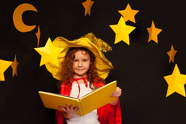 istock Little sky watcher studying stars with big book 539943510