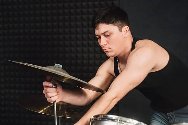 Photo of Drum player tuning his drums close-up