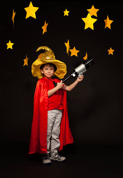 istock Six years old boy playing stargazer with telescope 539944070
