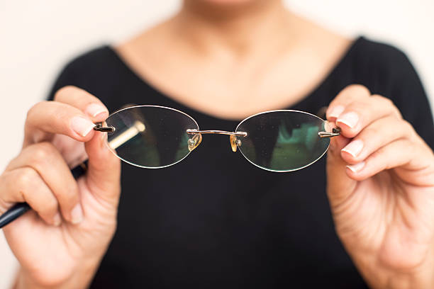 istock Woman Holding Eyeglass 539944348