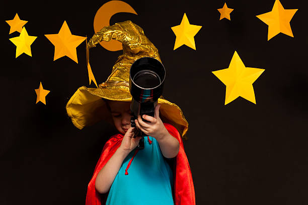 istock Little child looking through a telescope 539944818