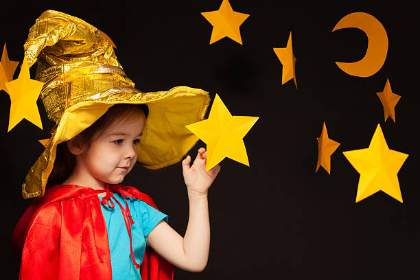 istock Little girl playing sky watcher with handmade star 539944962