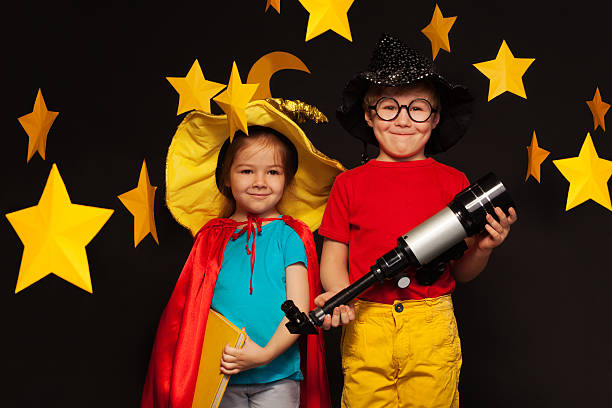 istock Cute kids playing sky watchers with a telescope 539945244