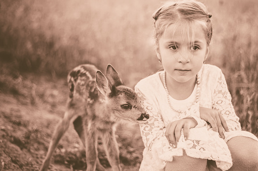 Cute girl with baby deer