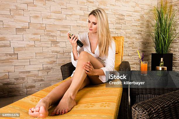 Beautiful Woman Treating Her Legs Stock Photo - Download Image Now - Tanning Bed, Applying, Women