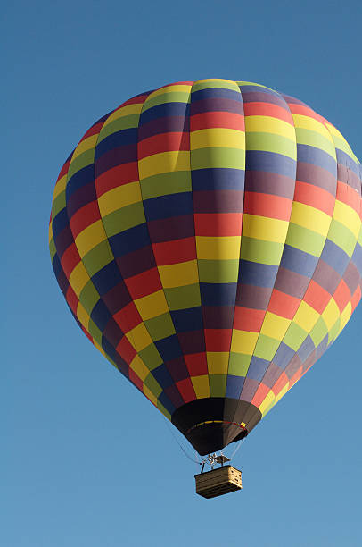 istock Rainbow Hot Air Balloon in Blue Sky Overhead 539945772