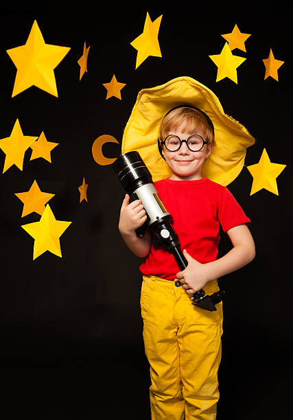 istock Young stargazer with telescope against starry sky 539945978