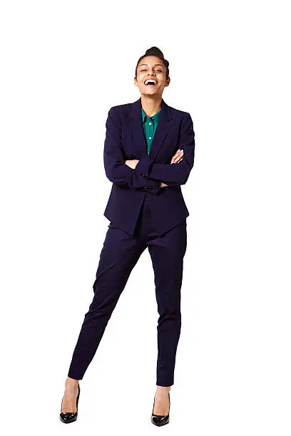 Full body portrait of successful young female business executive standing on white background