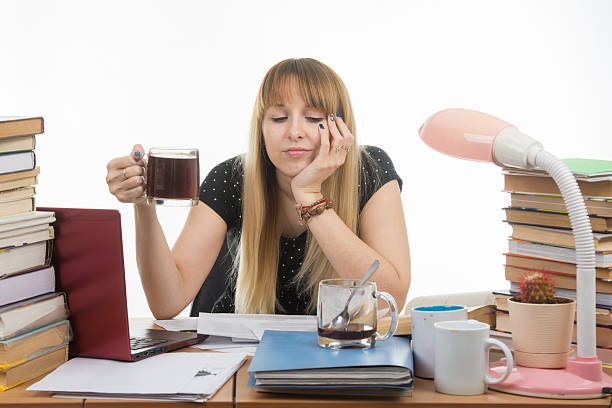 istock Girl student sadly and sleepily reading his thesis project 539948532