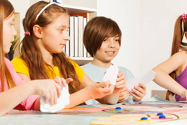 istock Four kids playing cards for a pastime 539948806
