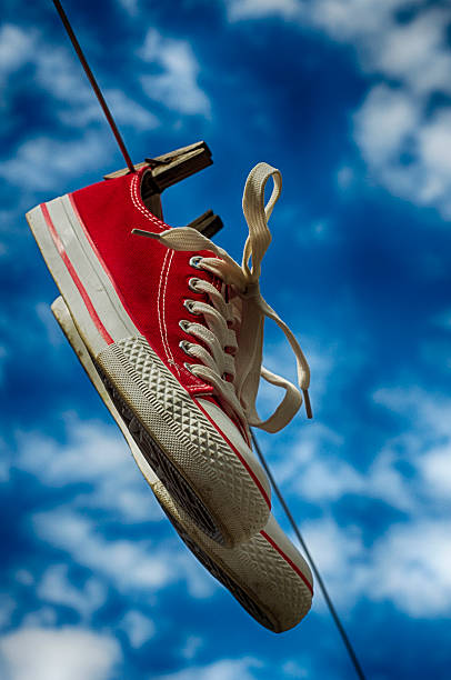 istock pair of red sneakers on clothesline 539949294