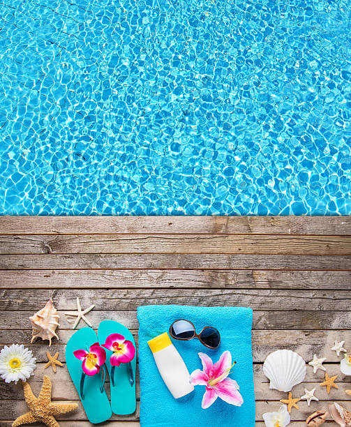 istock Beach accessories on wooden background with pool 539949384