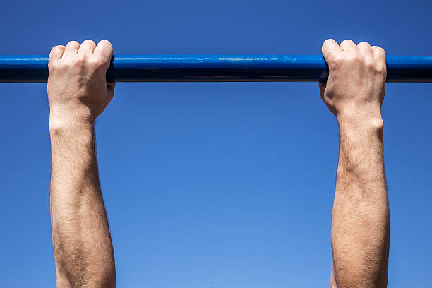istock hands of man which tightened on a horizontal bar 539949540