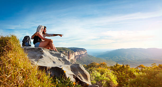Young couple traveling in the mountains Young traveling couple having rest on the rock and enjoying view in Blue Mountains in Australia blue mountains australia photos stock pictures, royalty-free photos & images