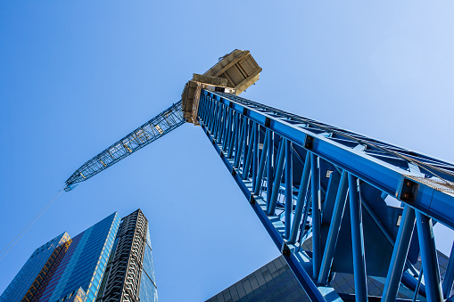 Crane construction on business building skyscraper facade