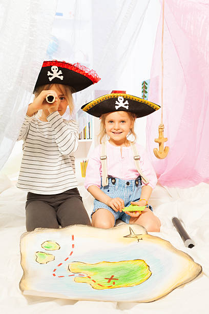 istock Two cute pirates looking through a toy spyglass 539952102