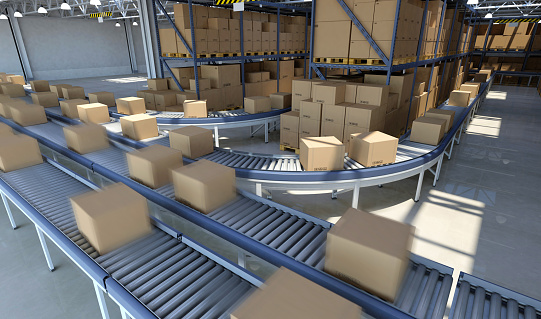 Boxes and packed goods moving on conveyor belt inside a large distribution warehouse building, with plenty of cardboard boxes and goods stacked on pallets on the background. Industrial system for storage, distribution and delivery services. Blurred motion effect on foreground packages. Digitally generated image.