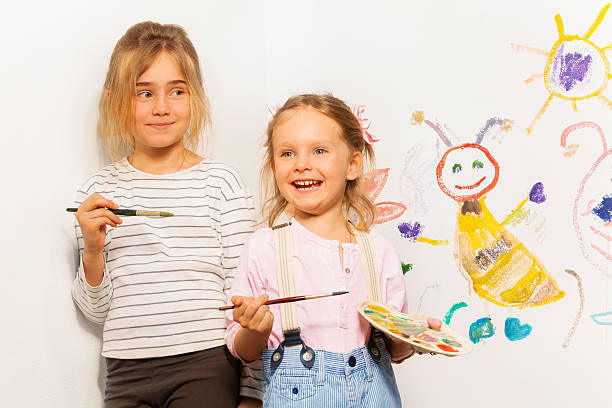 istock Two smiling painters drawing funny picture 539952648