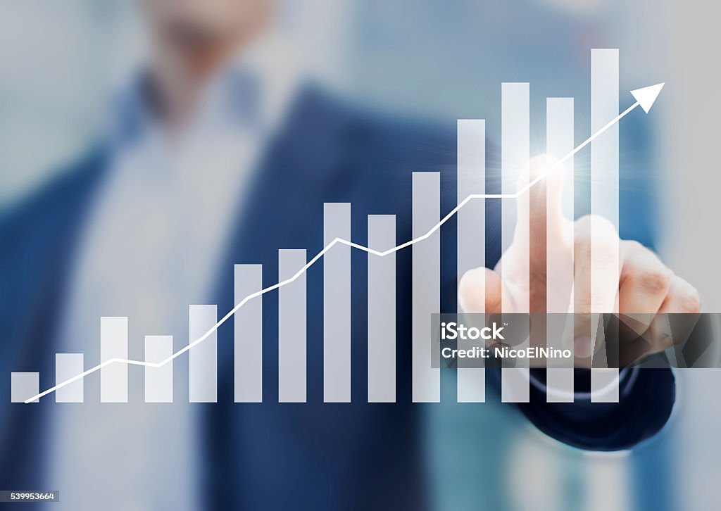 Business success with growing, rising charts and businessman in background Growth Stock Photo