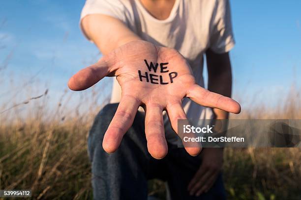 We Help Helping Hand Stock Photo - Download Image Now - Refugee, Greeting, Refugee Camp