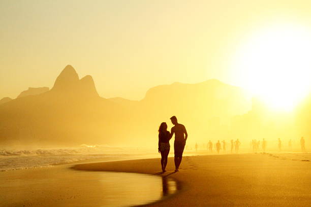 Couple walking on Ipanema´s sunshine stock photo