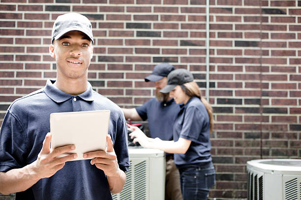 istock Air conditioner repairmen work on home unit. Blue collar workers. 539958466