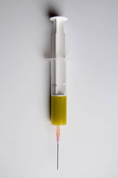 istock Medical Syringe with green serum 539958816