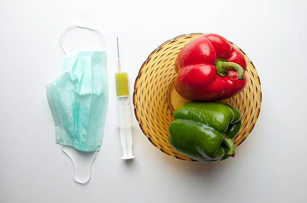 Green and reed pepper with syringe. GMO Green and reed pepper with syringe. GMO genetic modification change improvement science stock pictures, royalty-free photos & images