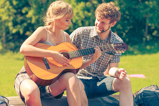 istock Young couple camping playing guitar outdoor 539960870