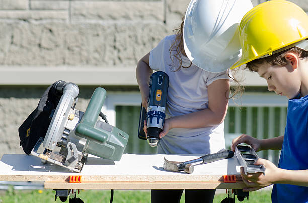 istock Little boy and girl playing with big tools outside 539960874