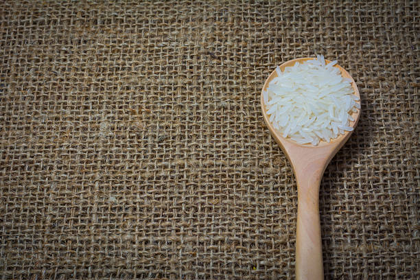 istock Rice with wooden Spoon on sack background 539965670