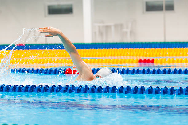istock Man swimmer swimming crawl in blue water. 539966334
