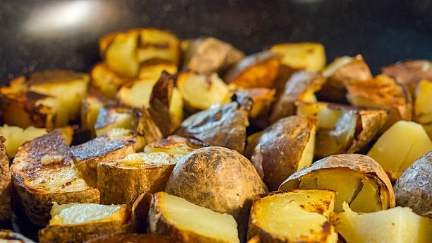 istock Roasted potato in a frying pan on wooden table 539972080