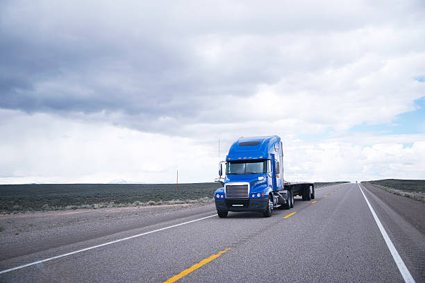 istock Flat bed semi-truck going to destination point for cargo 539972904