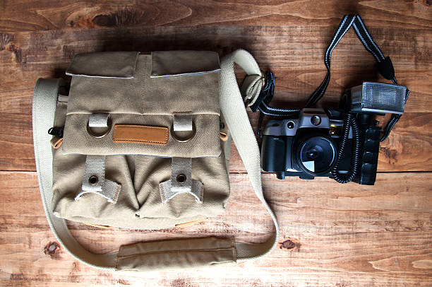 istock Old camera and bag, wooden background 539973472