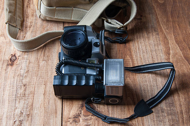 istock Old camera and bag, wooden background 539973522
