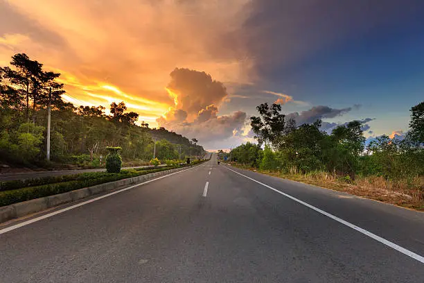 tropical road in jungle with cloudy sky, brilliant colors a scenic view of PhuQuoc island, Vietnam