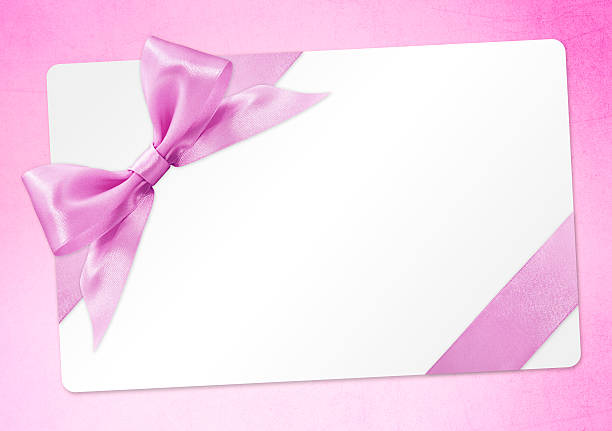 istock gift card with pink ribbon bow Isolated on pink background 539980232