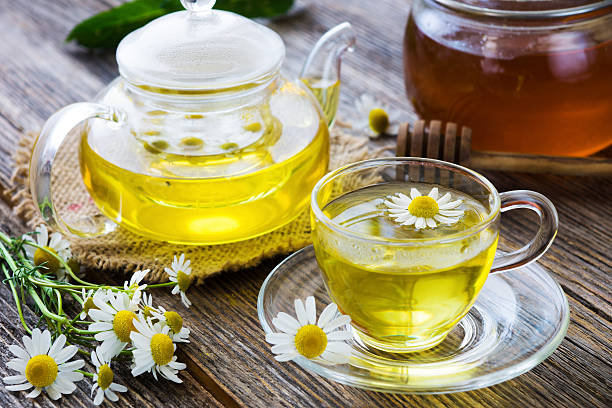 istock Chamomile tea on wooden background 539980772