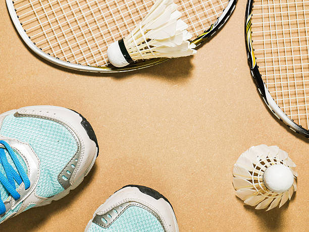 istock blue sport shoes and shuttlecocks with two badminton racket 539980918