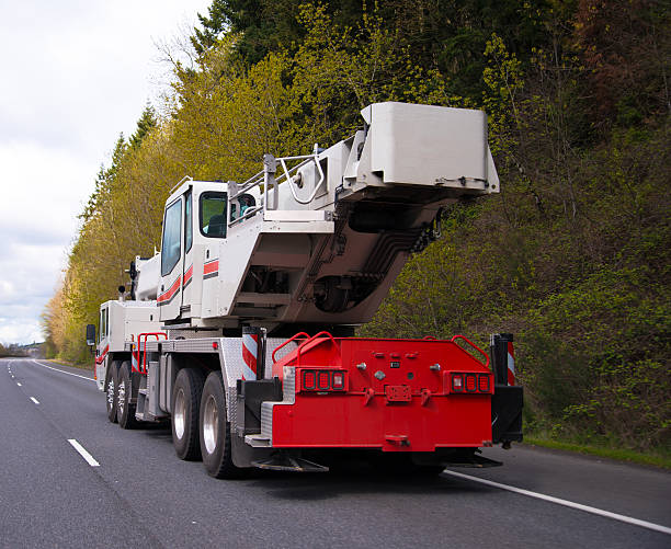 istock Large wheeled mobile portable crane with extendable boom on road 539981414
