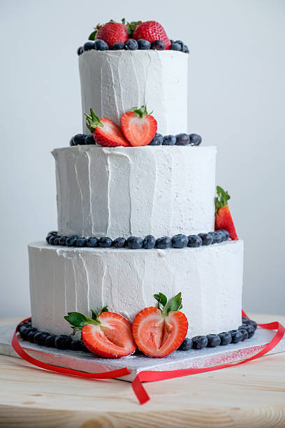 istock big white cake decorated with red strawberry and black berry 539983470