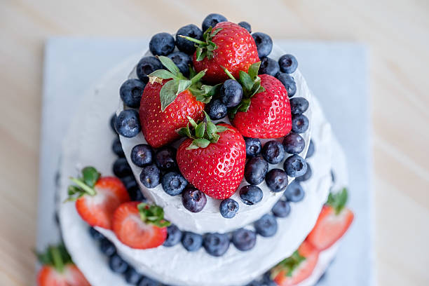 Fruit juicy cream cake with biscuit, cream cheese, strawberries, blueberries and whipped cream. Refreshing dessert