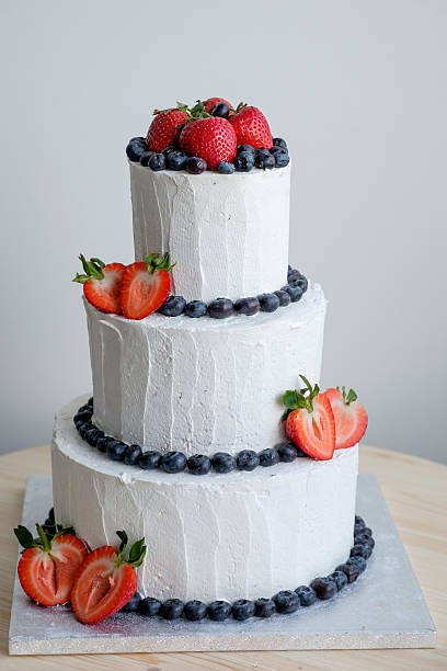 istock big white cake decorated with red strawberry and black berry 539983634