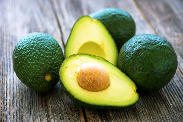istock Avocado on wooden background 539984414