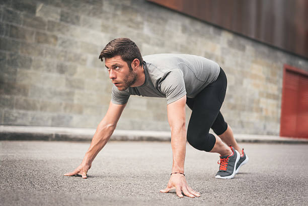 istock Male athlete ready for running and training on urban asphalt 539985030