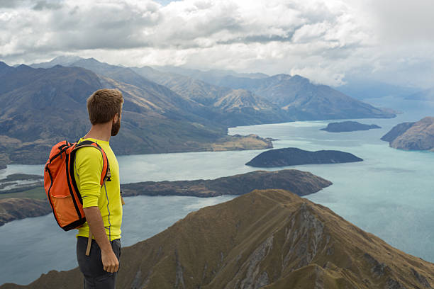 istock Hiker stands on a mountain top and looks at view 539985422
